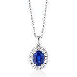 18ct White Gold Four Claw Set Oval Cut Sapphire and Round Brilliant Cut Diamond Halo Cluster Pendant and Chain