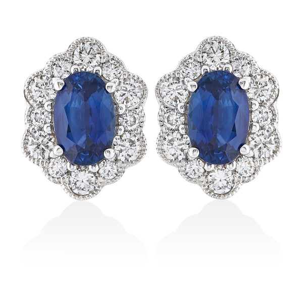 18ct White Gold Four Claw Set Oval Cut Sapphire and Round Brilliant Cut and Diamond Halo Cluster Stud Earrings