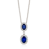 18ct White Gold Four Claw Set Oval Cut Sapphire and Round Brilliant Cut Diamond Halo Cluster Pendant and Chain
