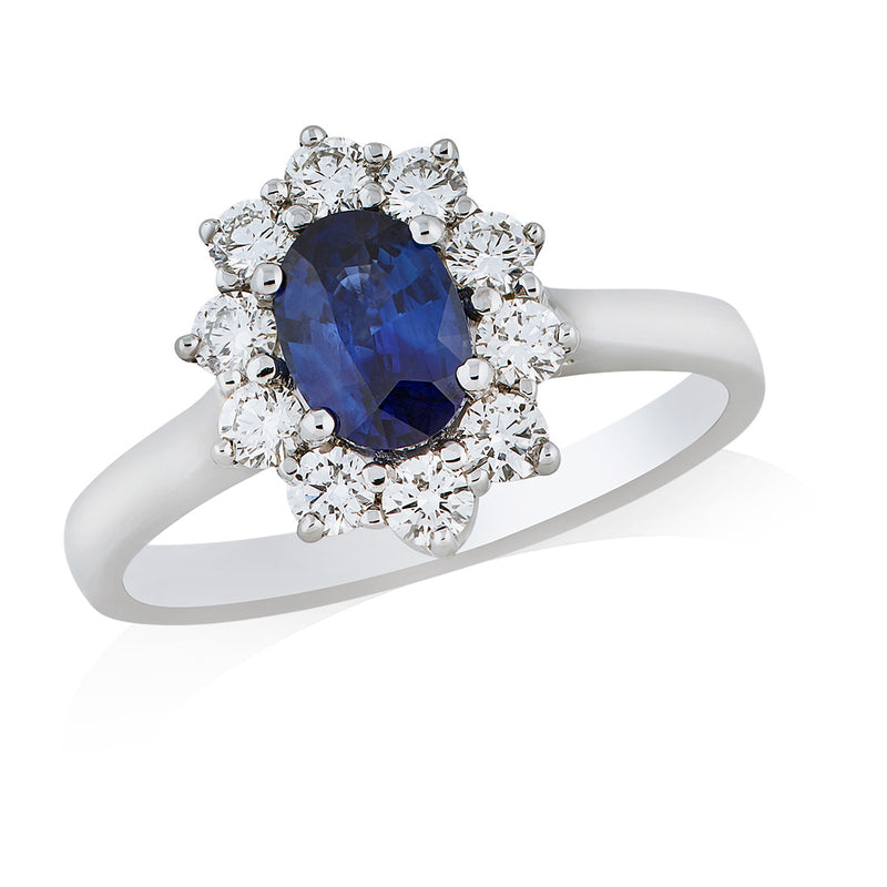 Platinum Four Claw Set Oval Cut Sapphire and Round Brilliant Cut Diamond Cluster Ring