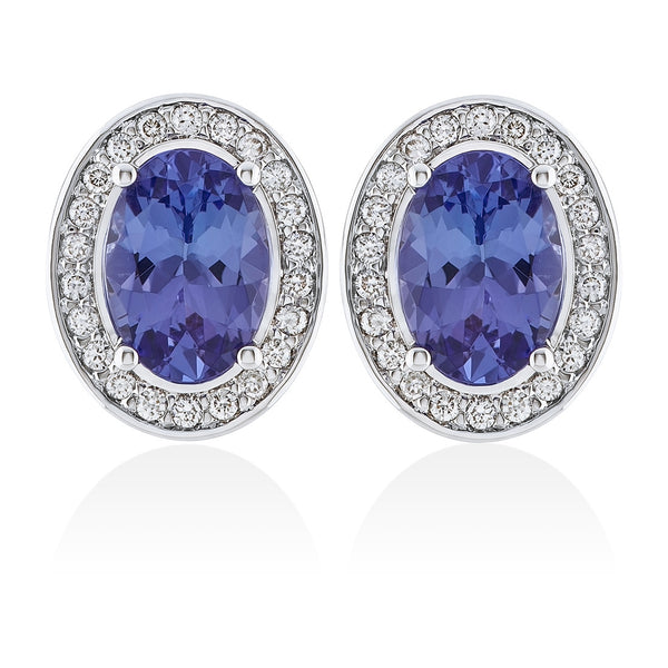 18ct White Gold Four Claw Set Oval Cut Tanzanite and Round Brilliant Cut Diamond Halo Cluster Stud Earrings