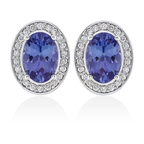18ct White Gold Four Claw Set Oval Cut Tanzanite and Round Brilliant Cut Diamond Halo Cluster Stud Earrings